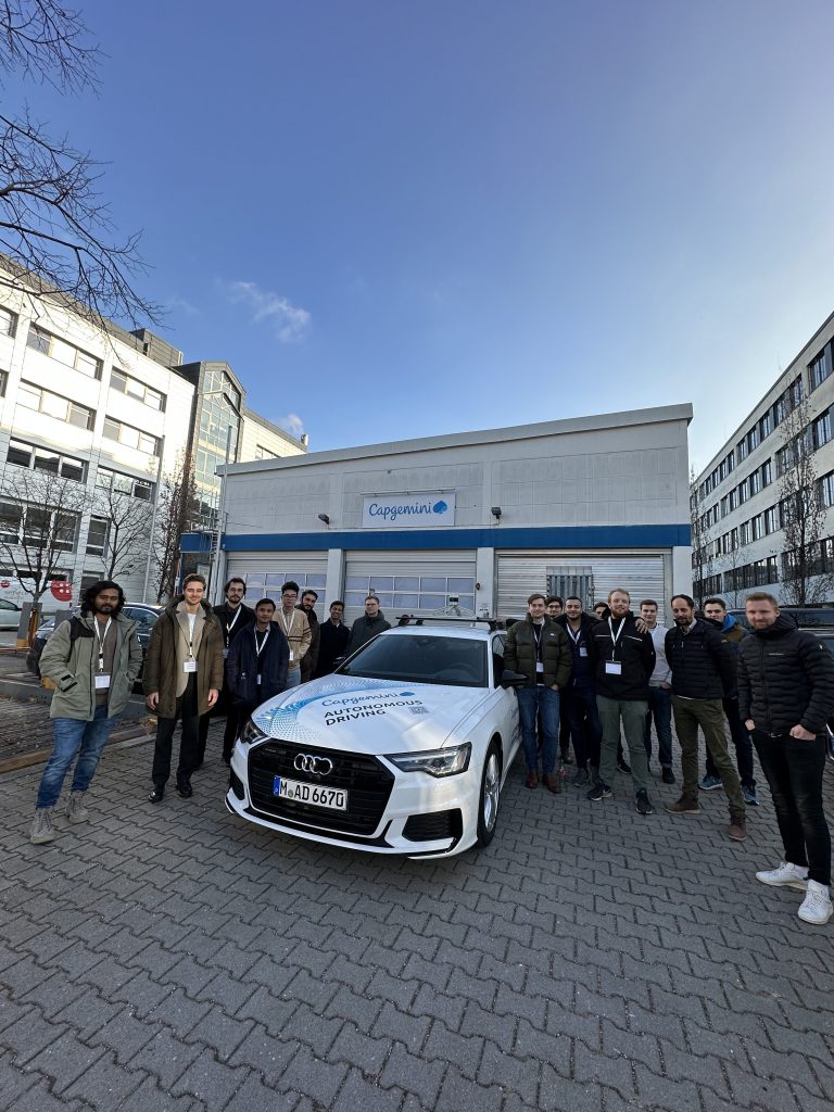 A group of people at our Talent Day, in front of a car